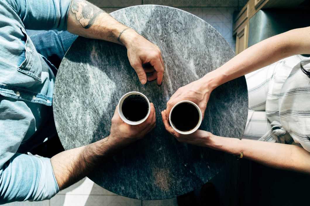 2 people drinking coffee together