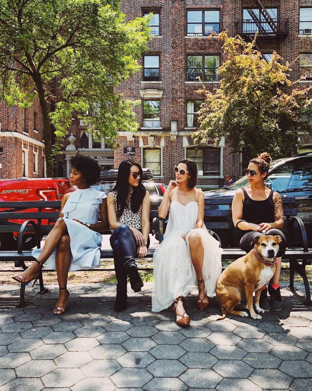 4 women sitting on a bench