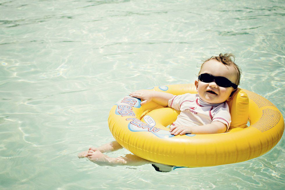 a baby in a float in a pool