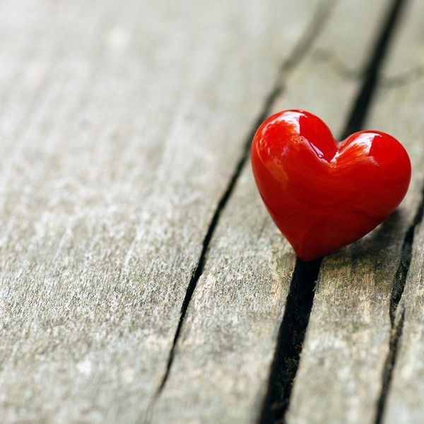 a heart shaped item on a wooden panel