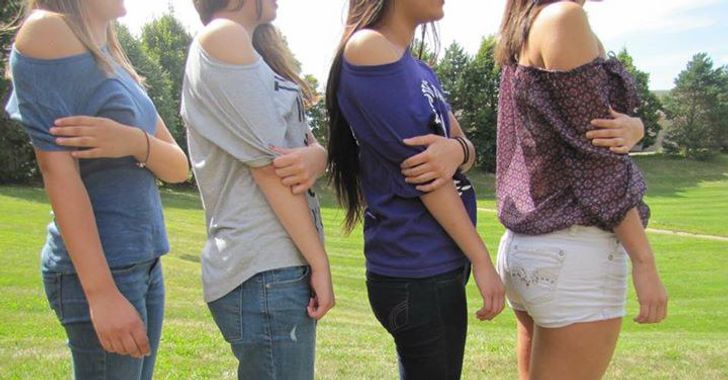 a line of women showing a shoulder