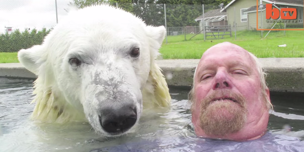 a man and a polar bear