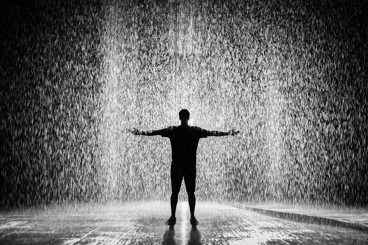 a man enjoys a rainfall
