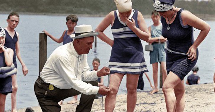 a man measuring a female's skirt