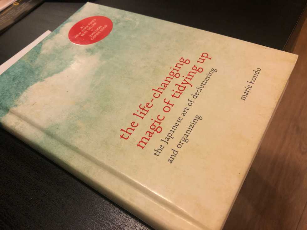 A photo of a book by Marie Kondo called “The Life-Changing Magic of Tidying up: The Japanese Art of Decluttering and Organizing.”