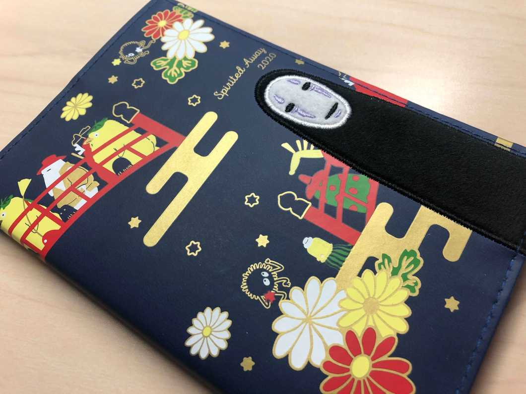 A photo of Samantha Incorvaia's 2020 planner. It's navy, and the designs are based on a Studio Ghibli Japanese animated movie called "Spirited Away."