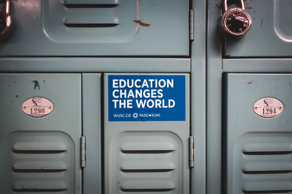 A sticker on a locjker that says Education changes the world