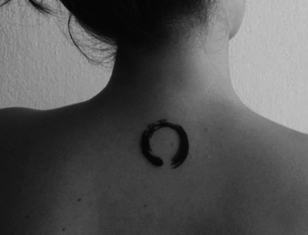 A zen circle tiny tattoo