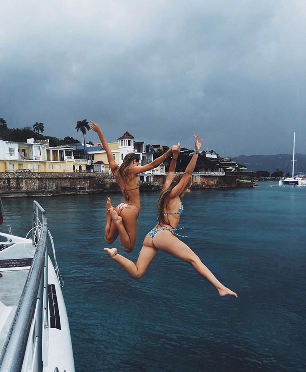 Alexis Ren and friend jumping into water