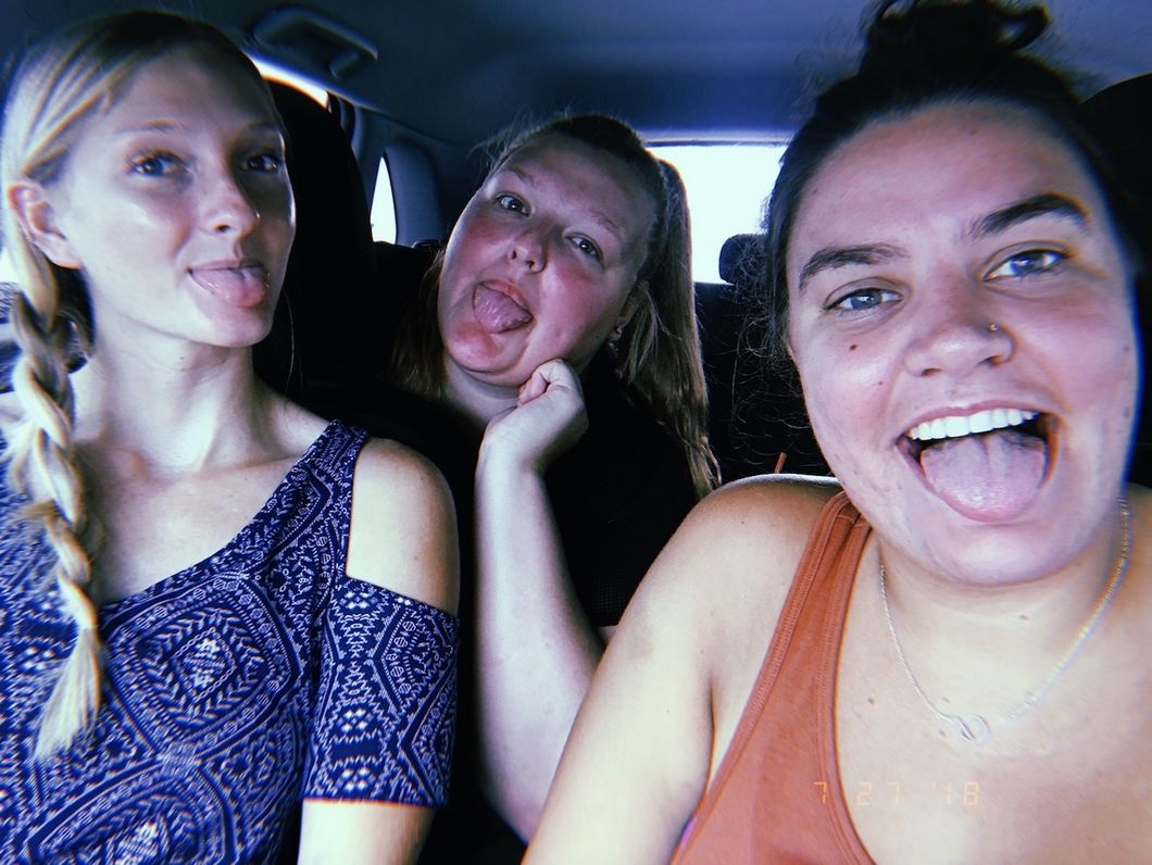Alyssa and her 2 best friends taking a selfie in a car
