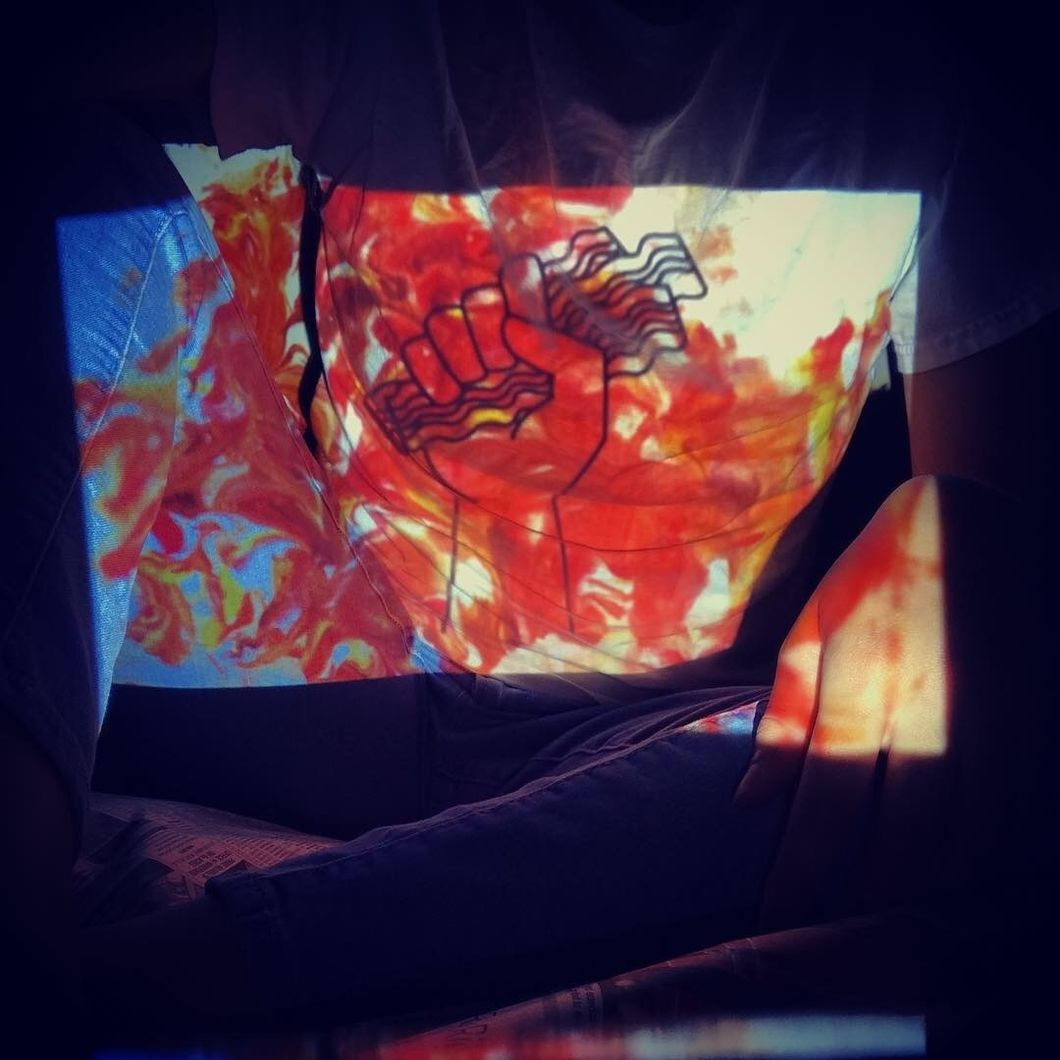 An art major student posing for her projection project.