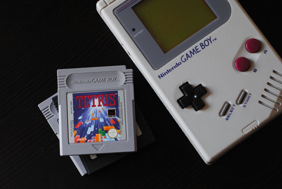 An old nintendo game boy with tetris.