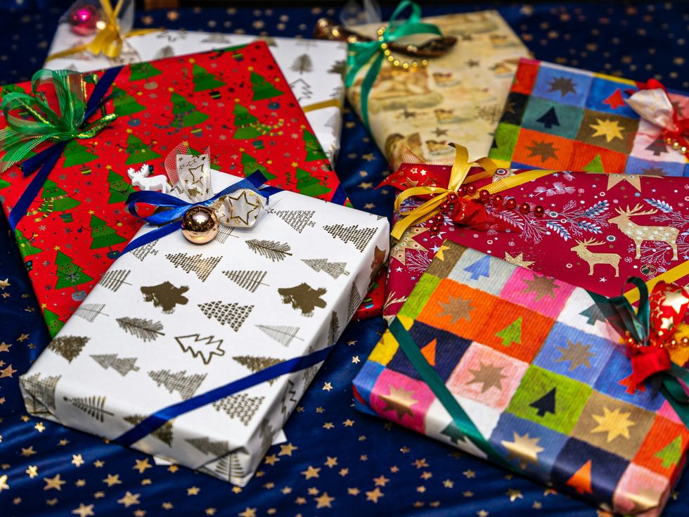Assorted colorful gift-wrapped presents with ribbons and bows