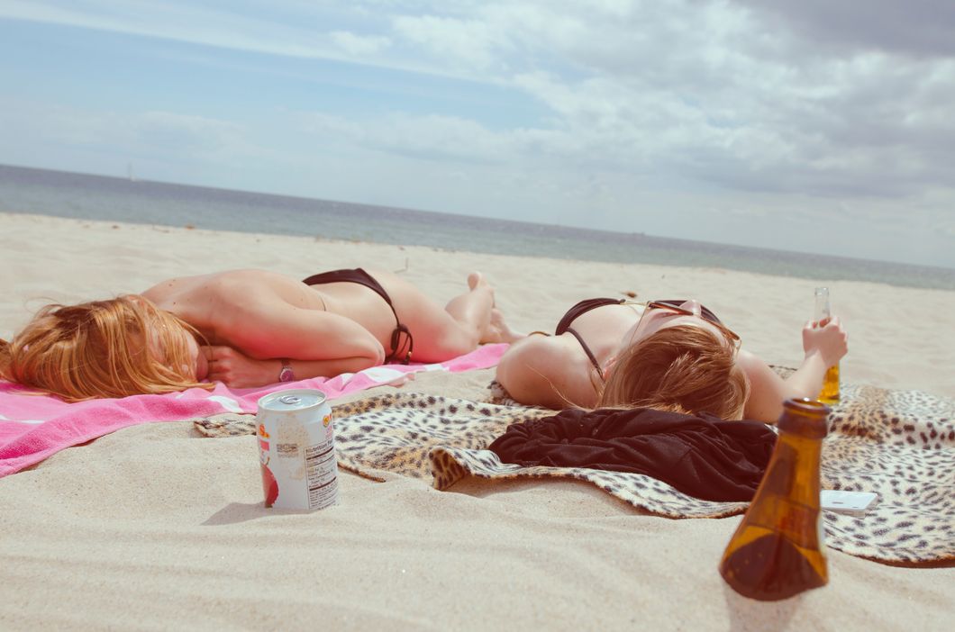 beautiful women lying on sunny beach