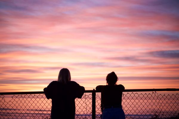 best friends take in a sunset