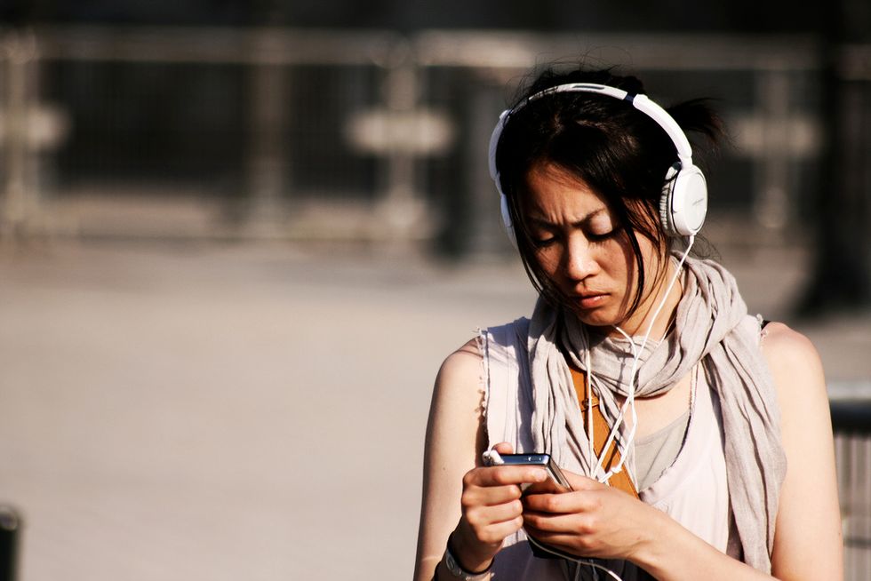 best girl friends listening to music sharing headphones