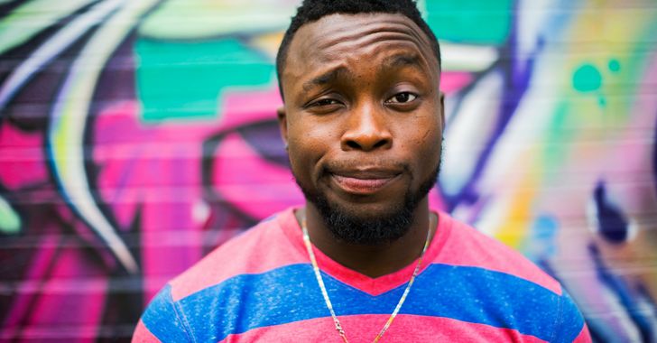 black haired man making face