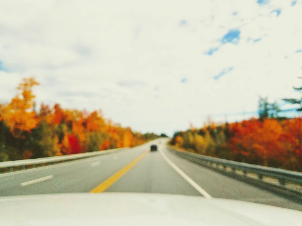 black vehicle on road during daytime