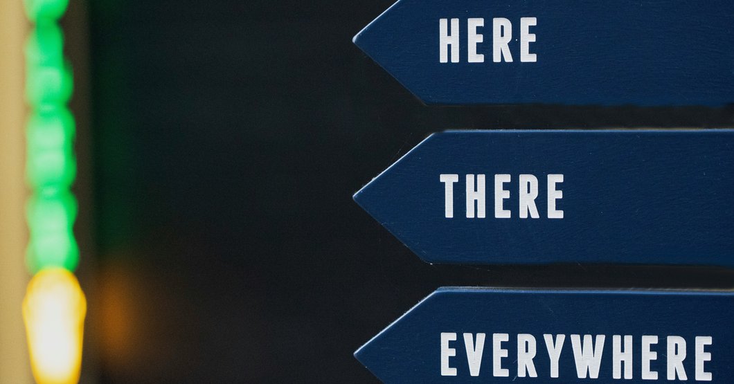 Blue Road signs that point and say here there and everywhere