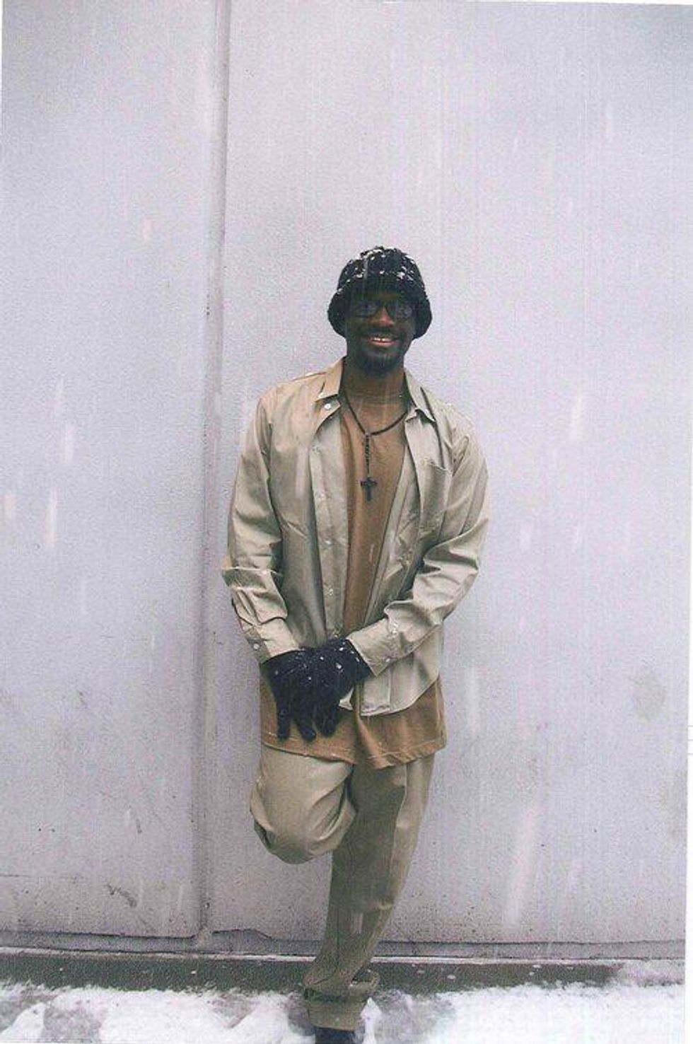 Brandon in the snow wearing a hat he crocheted 