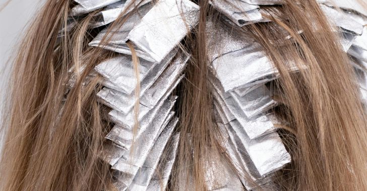 brown hair with aluminum foil on hair pieces