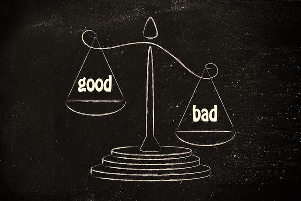 Chalk drawing of scales weighing "good" and "bad" on a blackboard.