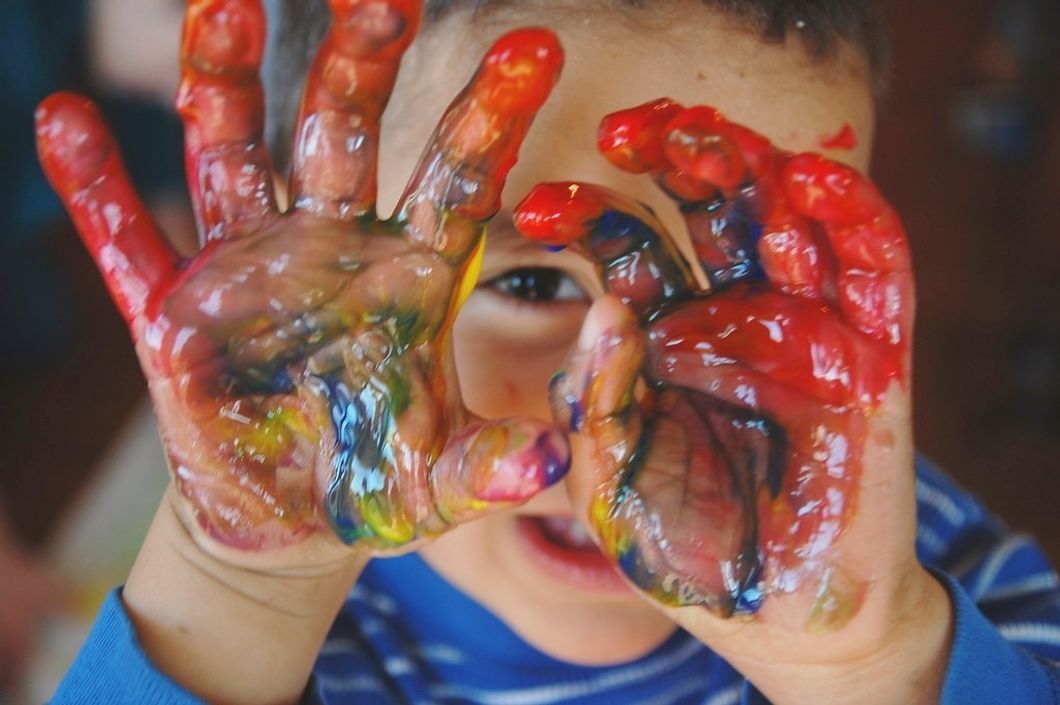 child with paint on his hands