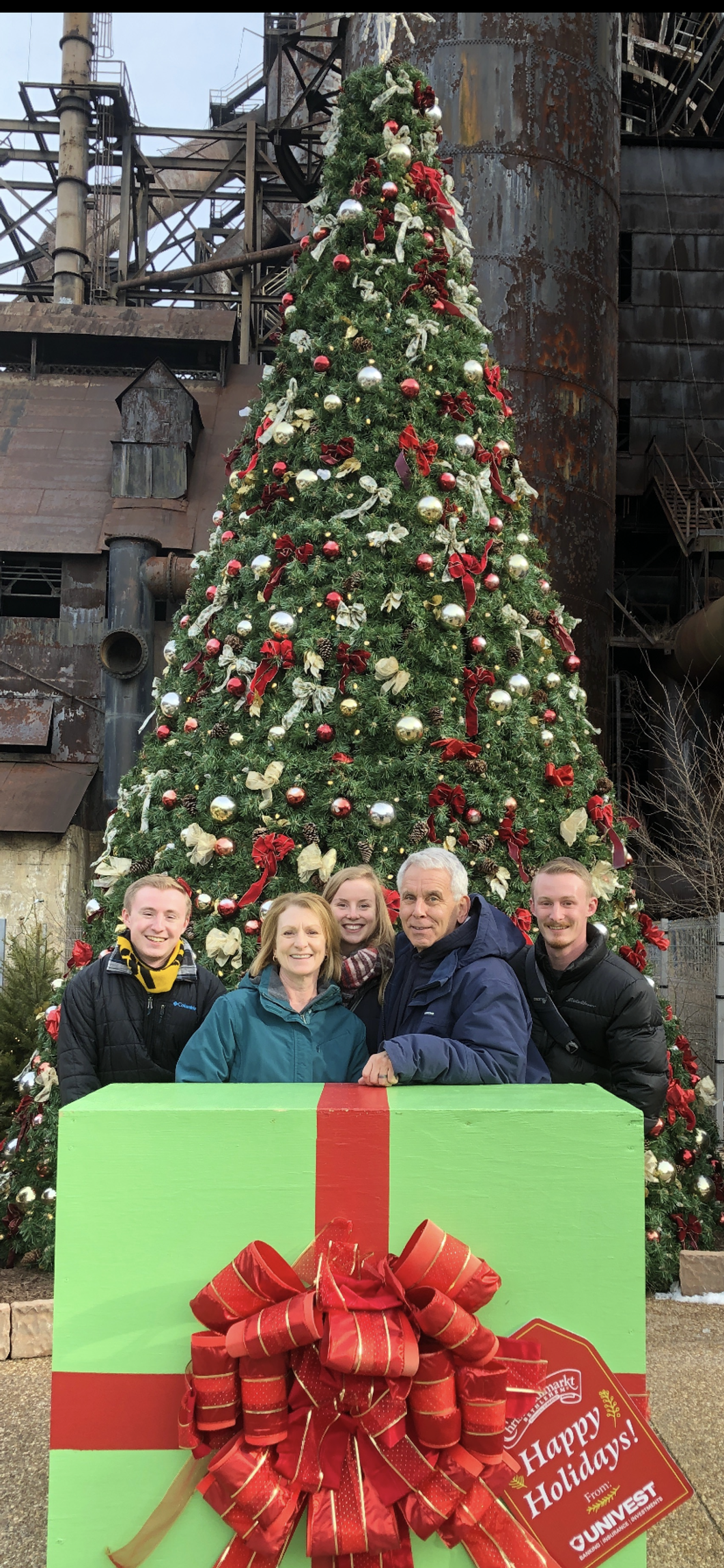 Colin Romaglia (left) stands in front of a Christmas Tree with his family in Pennsylvania.