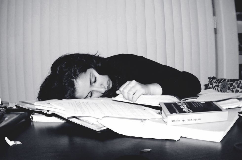 college student sleeping studying homework