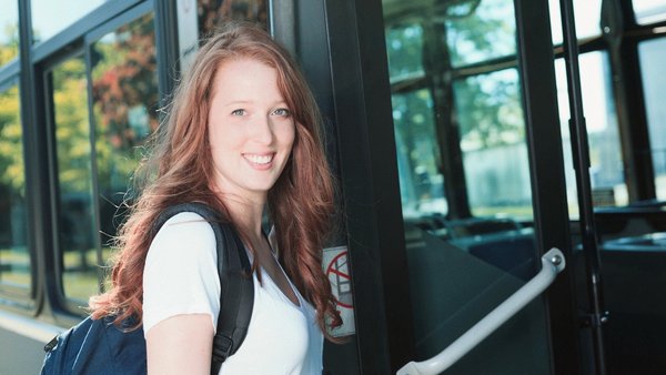 college student taking campus bus to summer classes