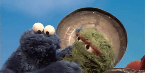 Cookie Monster hugging Oscar from Sesame Street