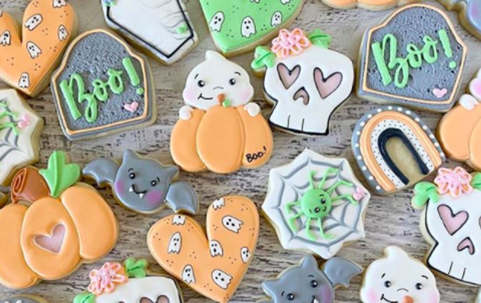 cookies shaped like pumpkins, gravestones, webs, skulls, and bats