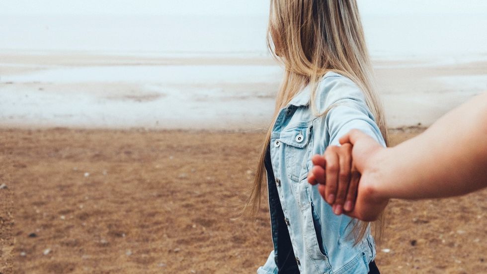 couple holding hands on the beach