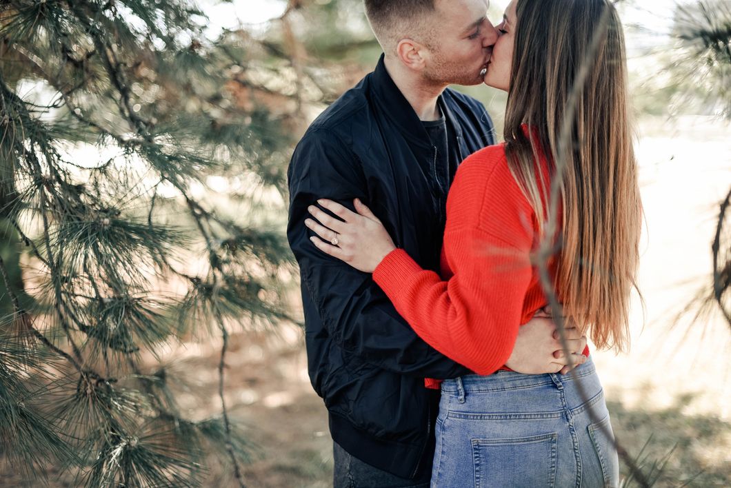 Couple kissing in a forest