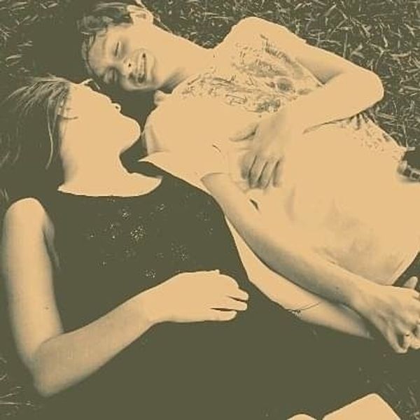 couple laying in the grass