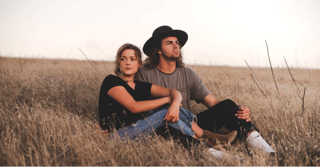 Couple sitting in a field