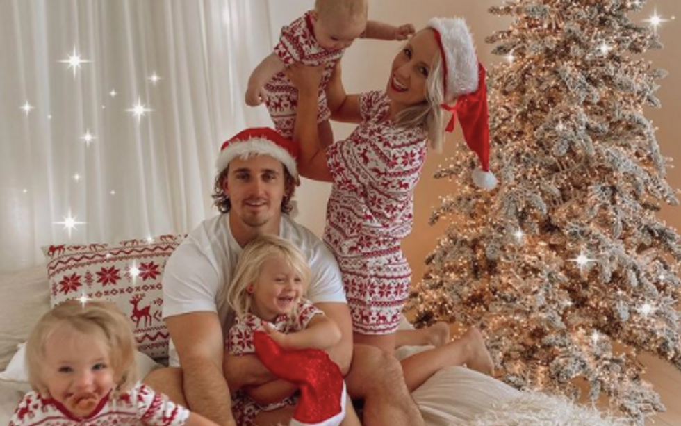 dad spends time with his family wearing matching holiday pajamas