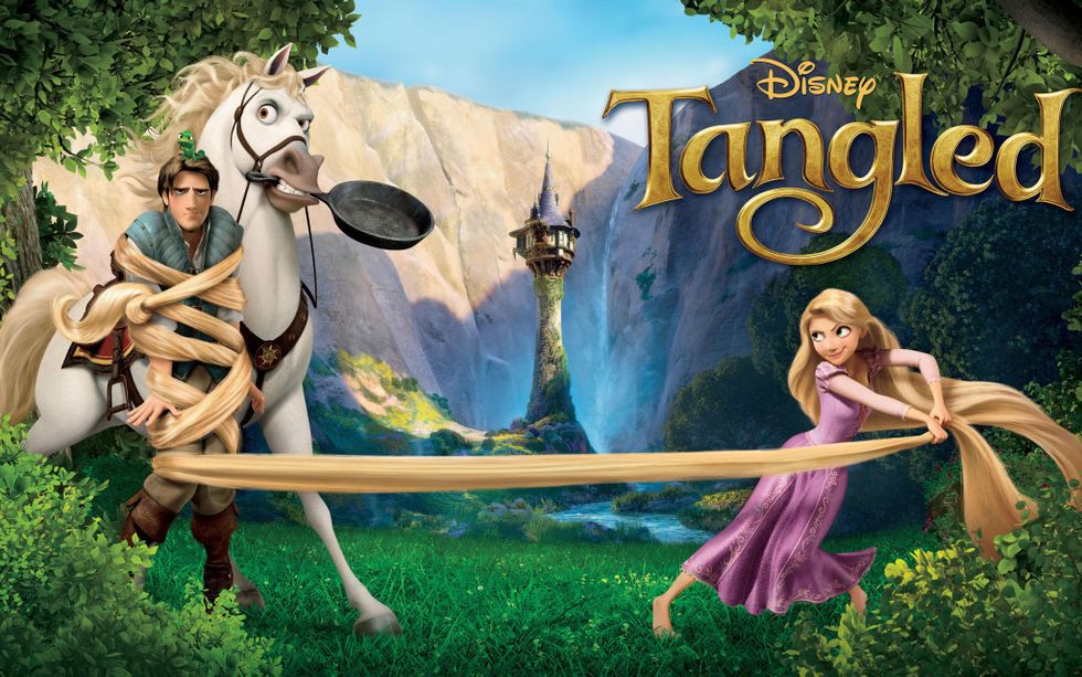 Disney's Tangled movie poster with Rapunzel tying up Flynn with her hair.