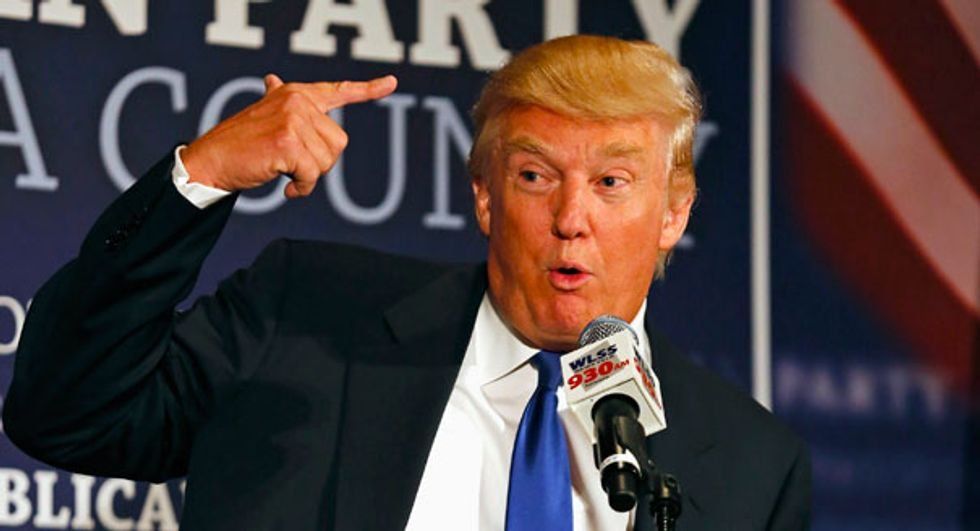 Donald Trump making a gesture pointing to his head while on a press conference