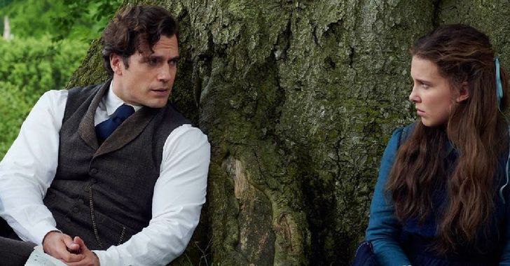 Enola Holmes movie - Man and women sat leaning against a tree