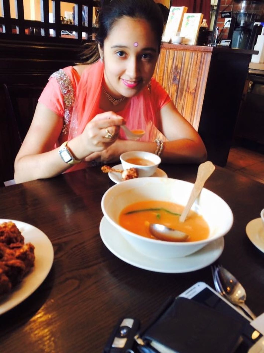 Erika eating some food at a restaurant