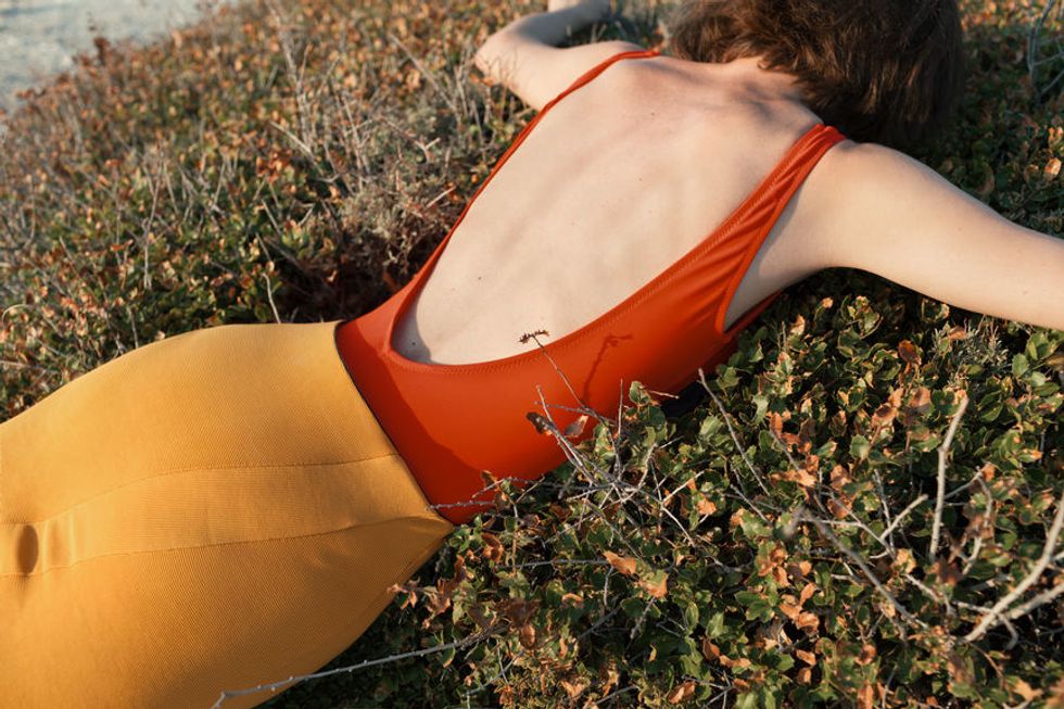 exhausted woman lays in the grass