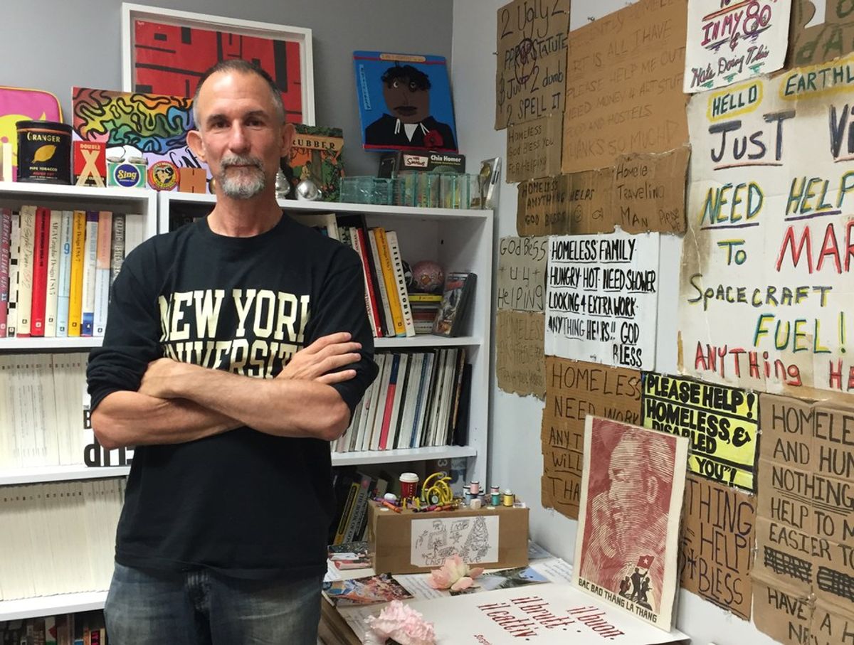 The Story Of 'We Are All Homeless'—The Dallas Artist Who Buys Signs From Homeless People