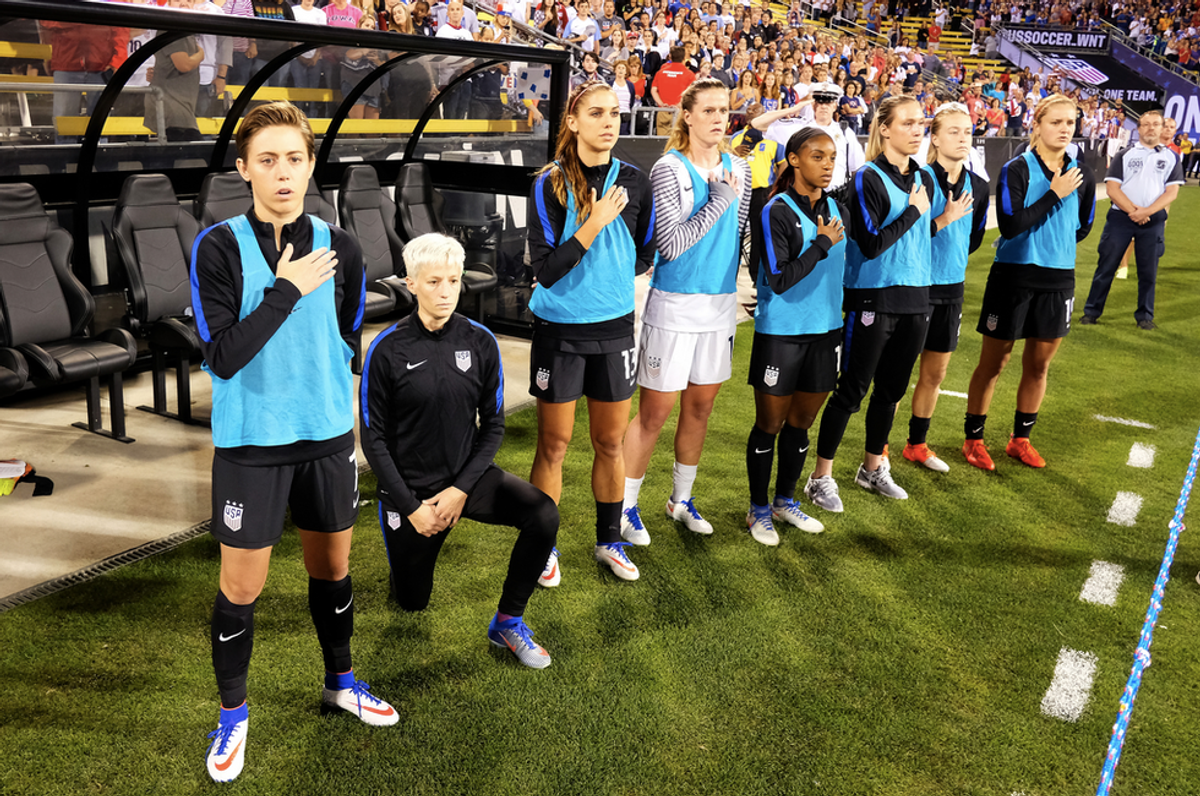 While Wearing A U.S. Uniform USWNT Midfielder Megan Rapinoe Kneels During The National Anthem