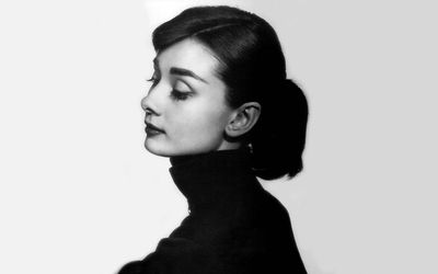 Film star, Audrey Hepburn makes a phone call holding her beloved
