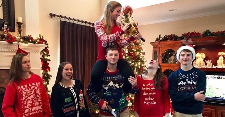 Family and friends in front of Christmas tree