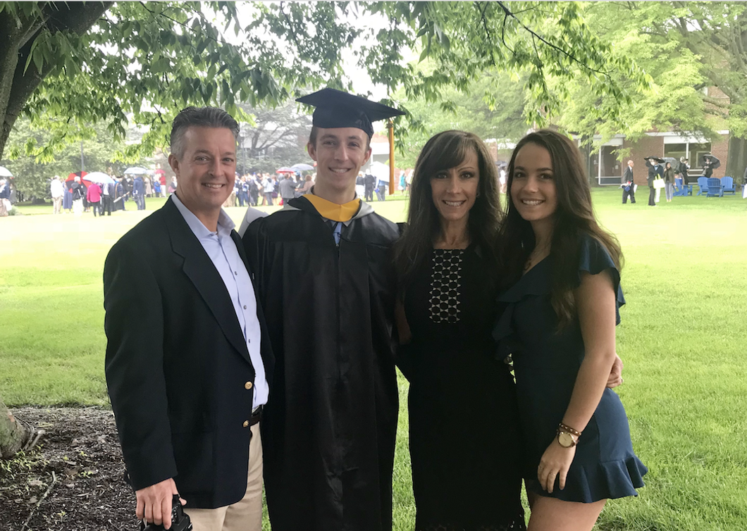 family posing for son's graduation photo
