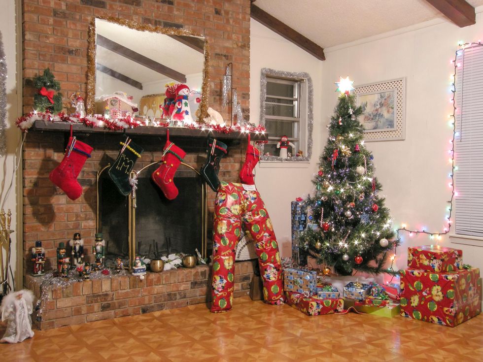 fireplace near Christmas tree and gift boxes