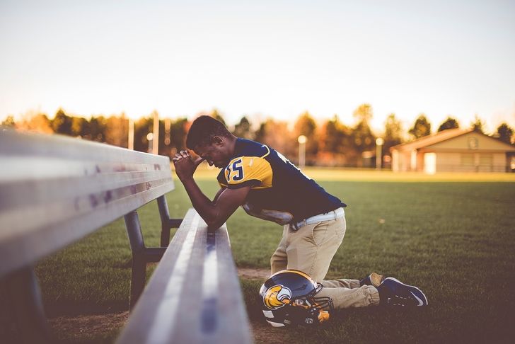 Football player kneeling
