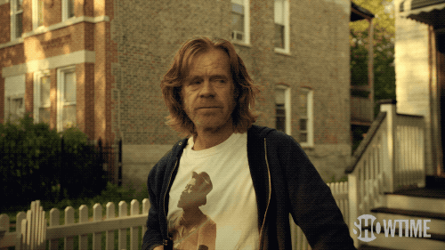 Frank Gallagher holds up his beer.